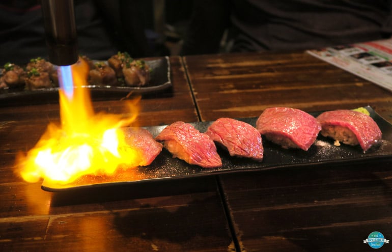 Flaming niku sushi on a Tokyo food tour