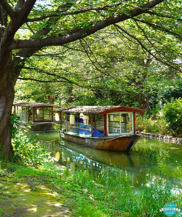 Old wooden Jukokubune Boats floating on a river in Fushimi, Kyoto