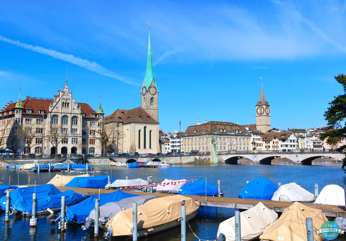 Fraumünster and St Peter church spires above boat moorings on the Limmat River, Zurich Switzerland