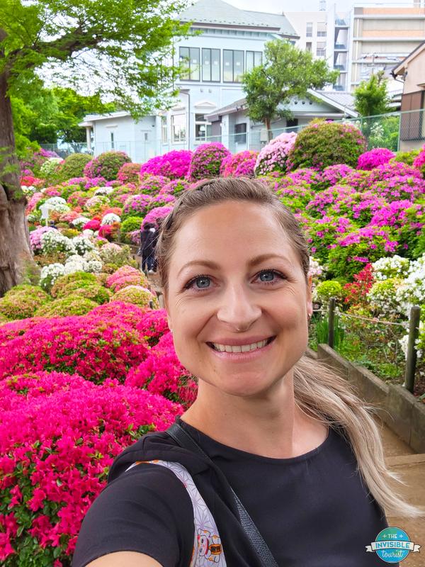 Alyse smiling in front of the azalea hillside at Nezu Shrine in Tokyo in April 2024