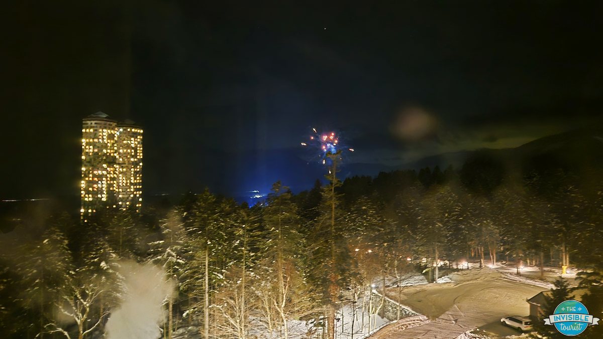 Fireworks over the Ice Village seen from a suite window at Risonare Tomamu at night