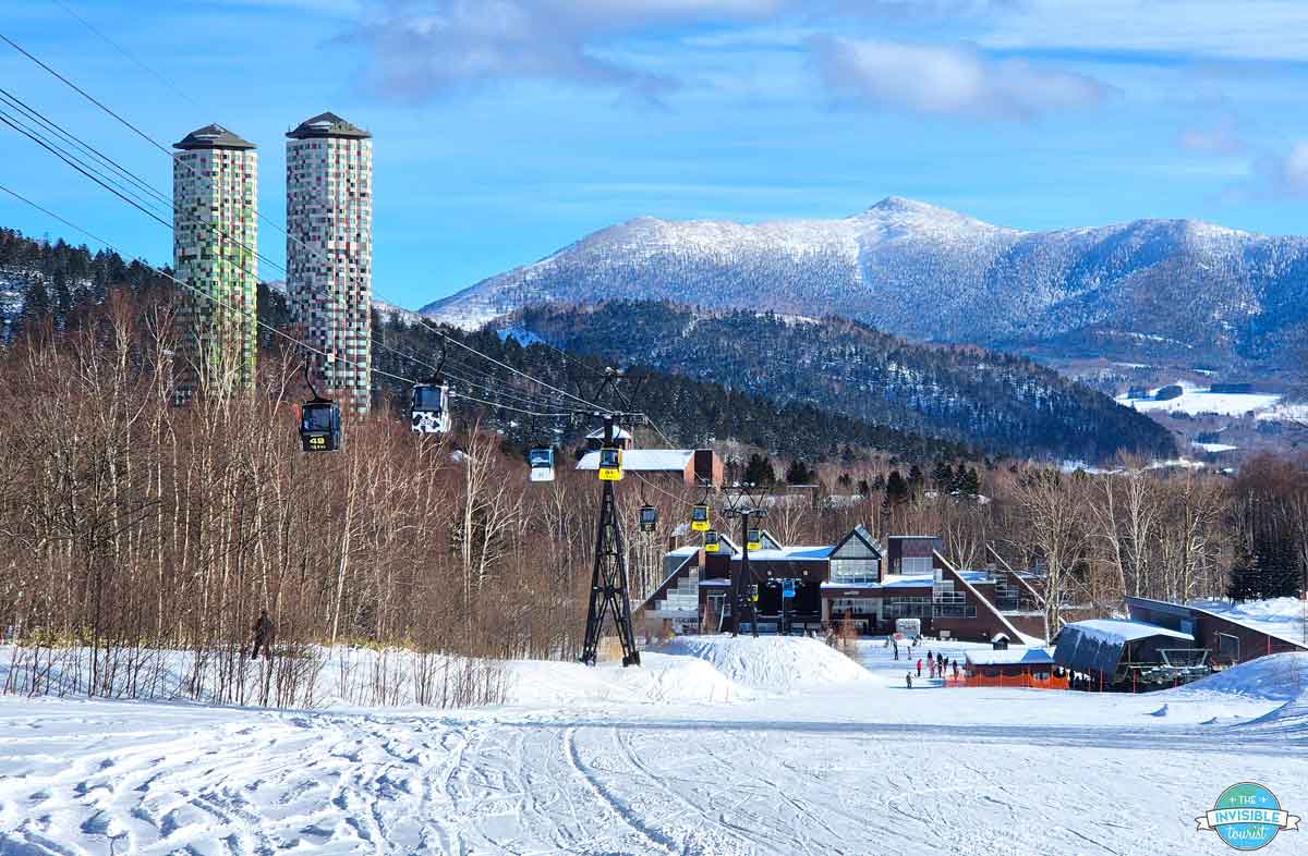 Risonare Tomamu towers and gondola under blue sky at Tomamu ski resort