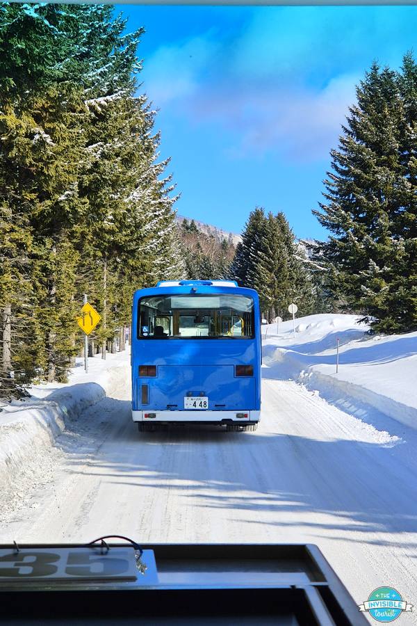 Hoshino Resorts Tomamu shuttle bus driving through snow from Tomamu Station