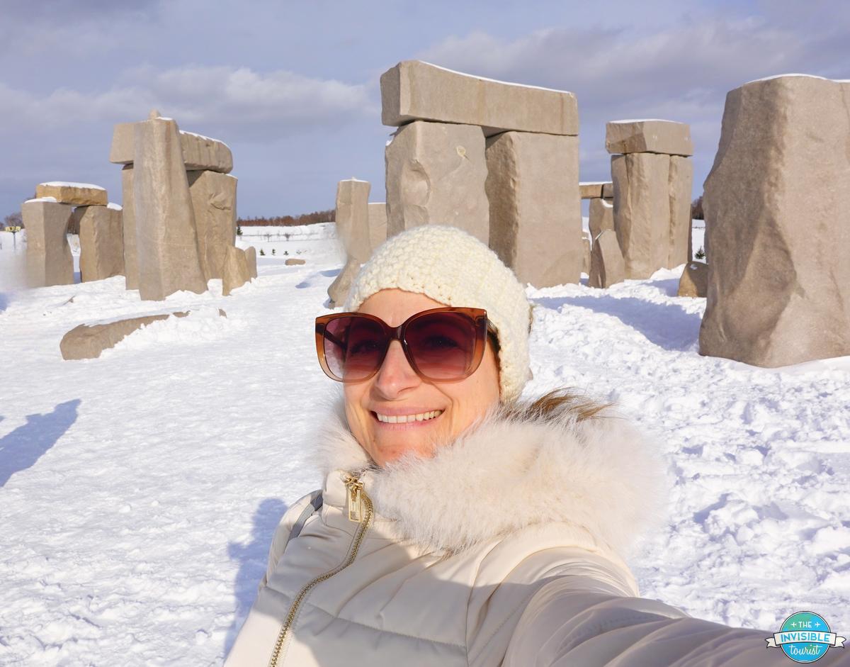 Alyse taking a selfie at the Stonehenge replica at Makomanai Takino Cemetery, Sapporo, in winter