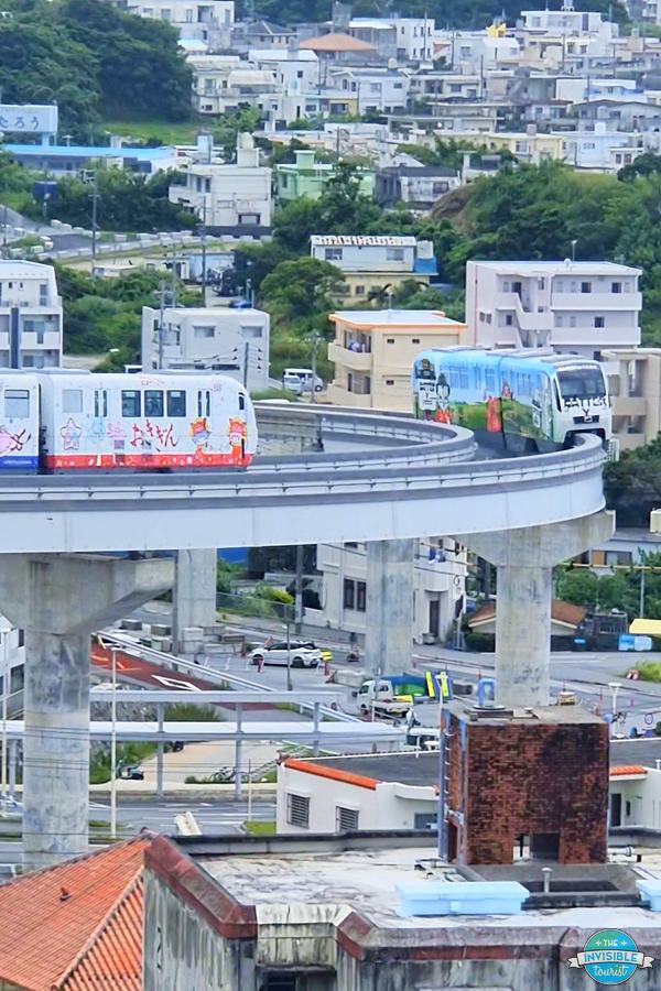 Two Yui Rail monorail trains passing on a curve in Urasoe, Okinawa